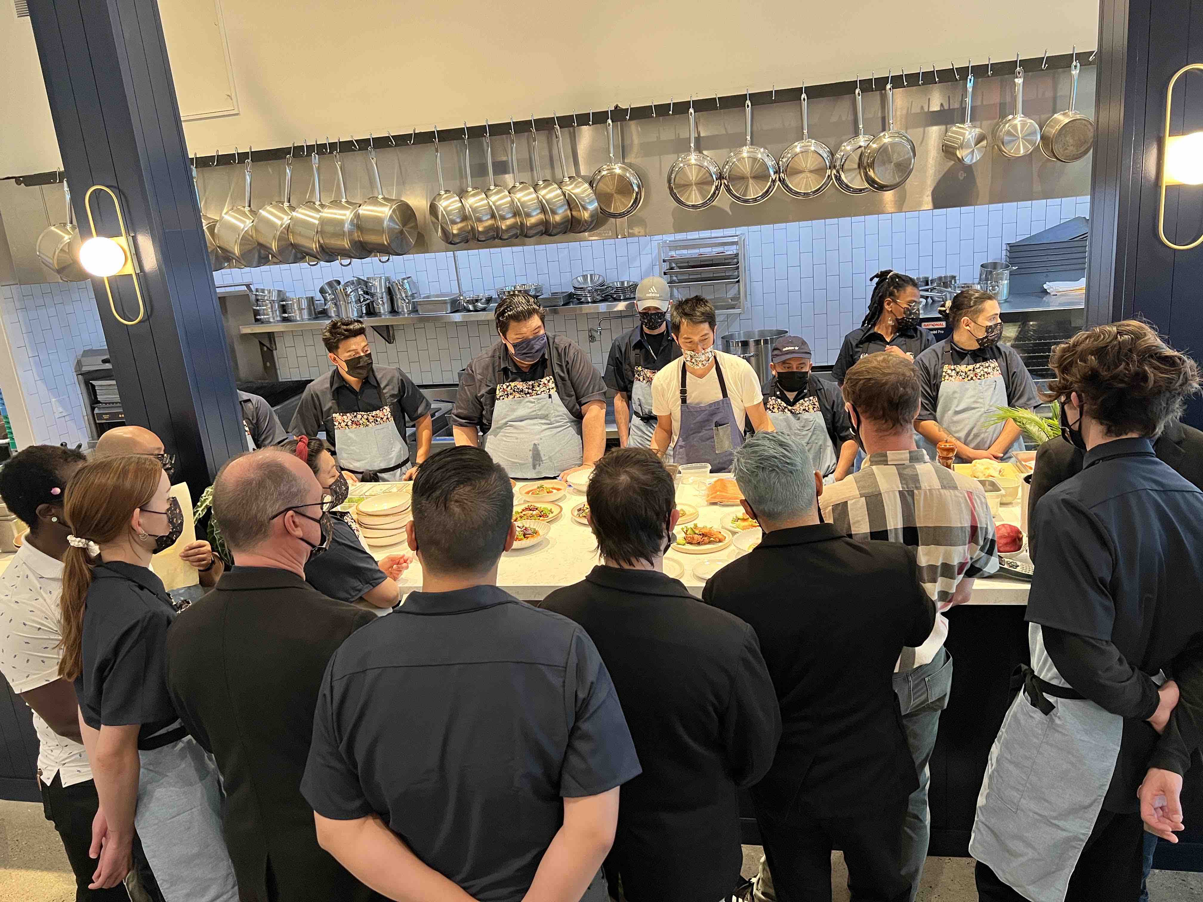 Cassava staff stand around the counter preparing for a new day