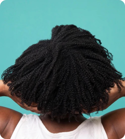 A woman with beautiful natural curls on a turquoise background